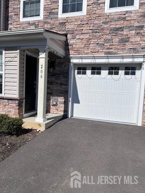 garage with aphalt driveway