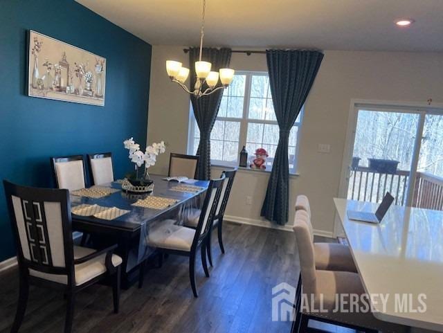 dining area with dark wood-style floors, recessed lighting, baseboards, and an inviting chandelier