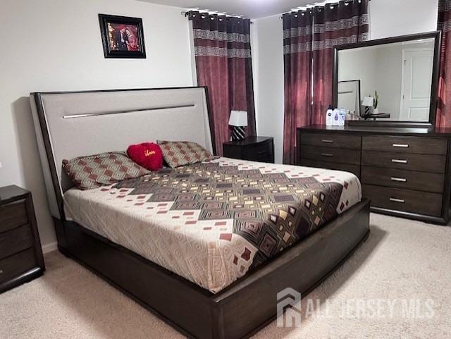 bedroom with light colored carpet