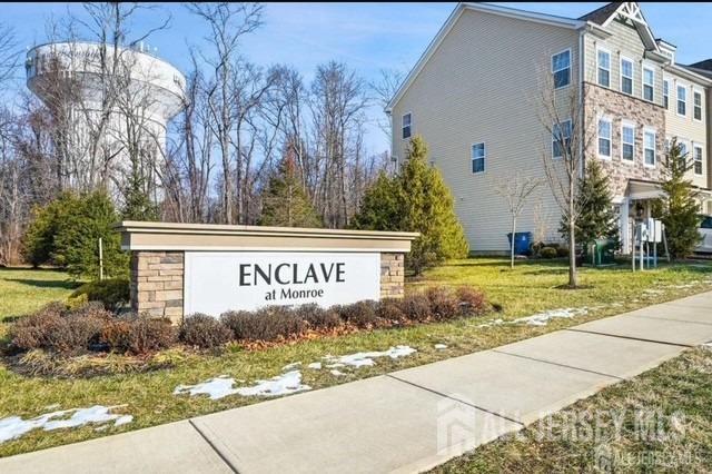 community / neighborhood sign featuring a lawn