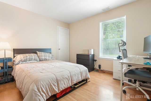 78 Pennsylvania Way N, Brunswick, NJ 08902 - bedroom with light wood-style floors, multiple windows, and a desk