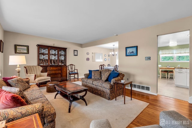 6 Onondaga St, Old Bridge, NJ 08857 - living room with a chandelier, light wood finished floors, and baseboards
