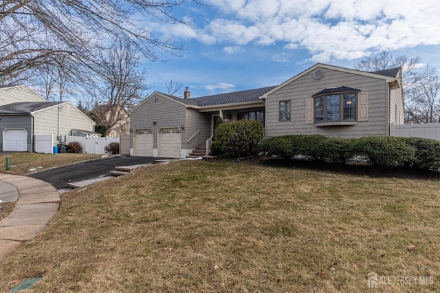 single story home with a garage and a front yard