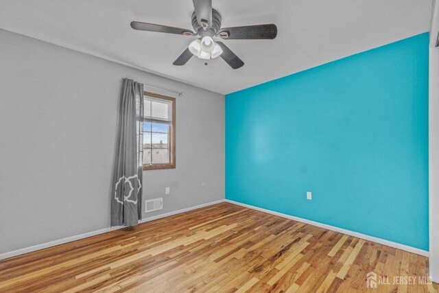 unfurnished room with ceiling fan and light hardwood / wood-style flooring