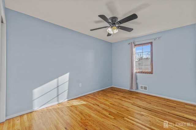 unfurnished room featuring light hardwood / wood-style floors and ceiling fan