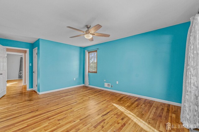 spare room with ceiling fan and light hardwood / wood-style floors