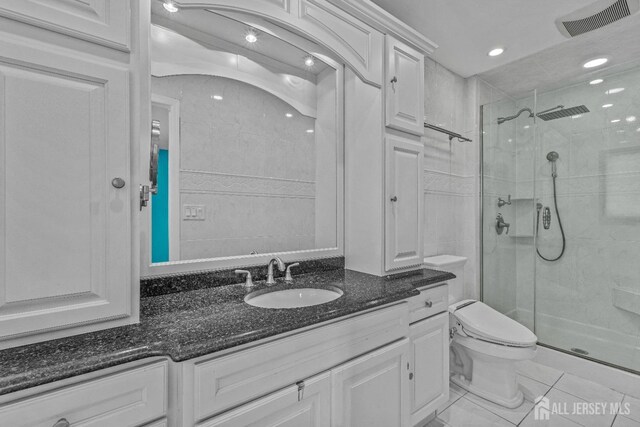 bathroom featuring vanity, an enclosed shower, and toilet