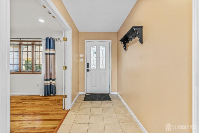 tiled foyer entrance with a wealth of natural light