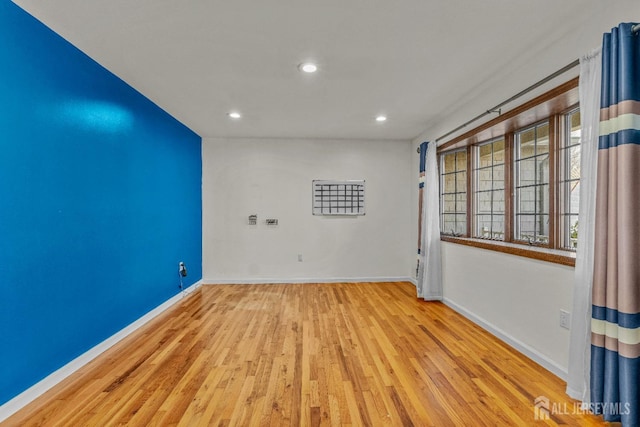 spare room featuring light hardwood / wood-style flooring