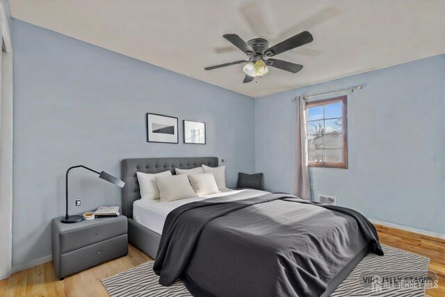 bedroom with light hardwood / wood-style flooring and ceiling fan