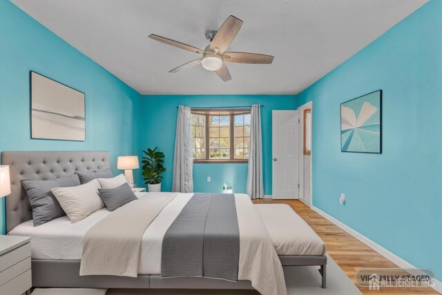 bedroom featuring ceiling fan and light wood-type flooring