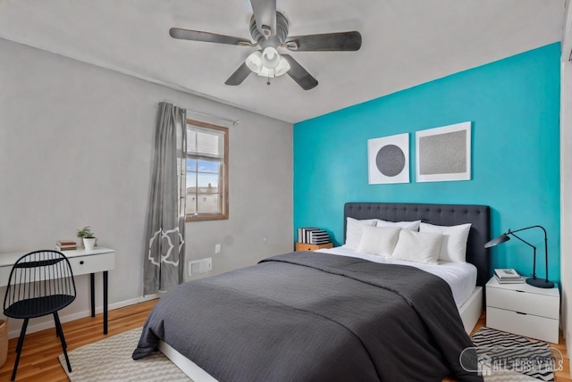 bedroom with ceiling fan and light hardwood / wood-style floors