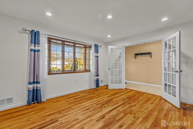 unfurnished room featuring light wood-type flooring and french doors