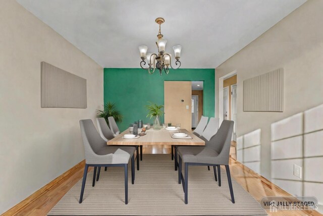 dining area featuring a notable chandelier and wood-type flooring