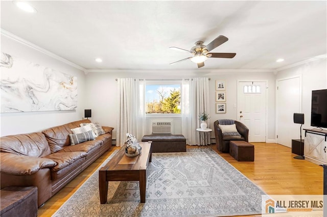 living room featuring light wood-type flooring, ceiling fan, and ornamental molding