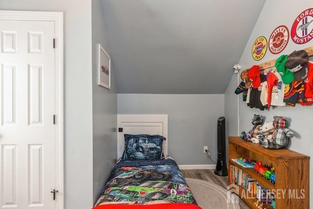 bedroom with hardwood / wood-style floors and vaulted ceiling