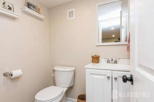 bathroom with toilet and vanity