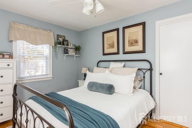 bedroom with light hardwood / wood-style floors and ceiling fan