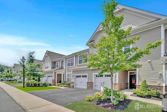 30 Grabowski Dr, Sayreville, NJ 08859 - craftsman house featuring an attached garage, asphalt driveway, stone siding, and a residential view