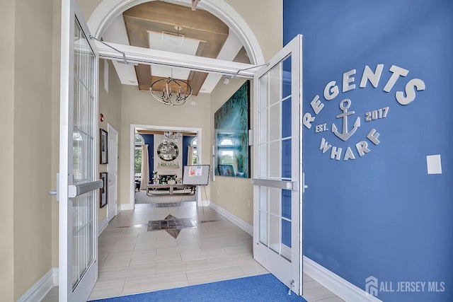 30 Grabowski Dr, Sayreville, NJ 08859 - corridor featuring a chandelier, french doors, and tile patterned floors