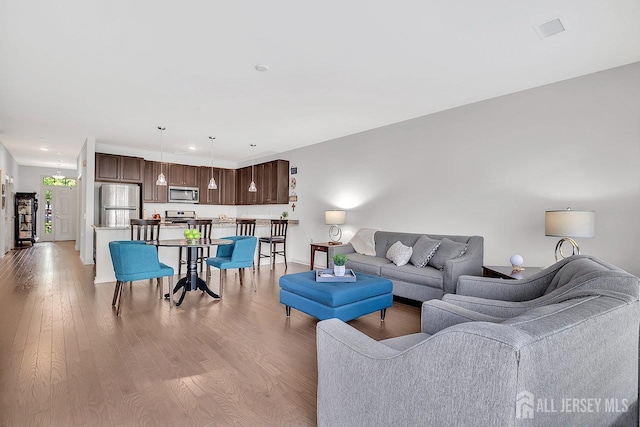 30 Grabowski Dr, Sayreville, NJ 08859 - living room with light wood finished floors and baseboards