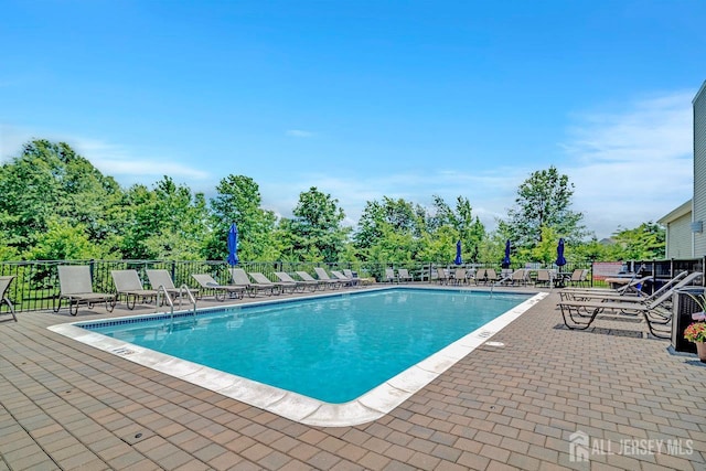 30 Grabowski Dr, Sayreville, NJ 08859 - community pool featuring a patio area and view of wooded area