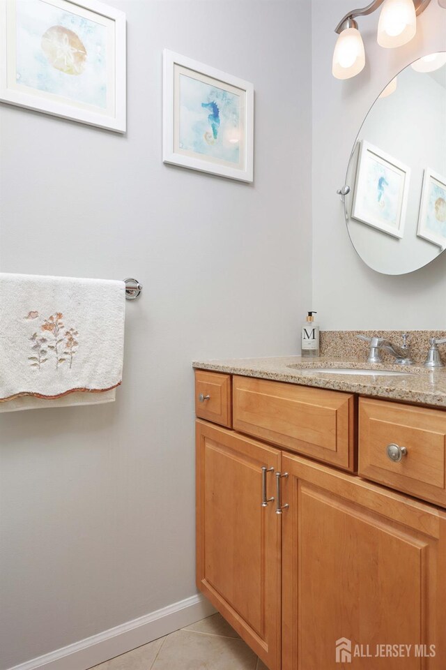 bathroom with tile patterned floors, vanity, and baseboards