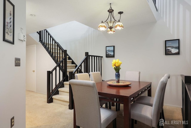 dining space featuring a chandelier, light colored carpet, and stairs