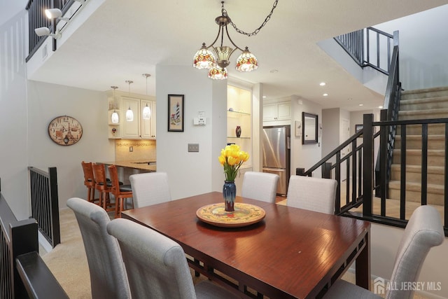dining area featuring stairs, recessed lighting, and a chandelier