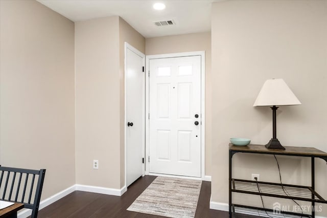 entryway featuring dark wood-style floors, visible vents, and baseboards