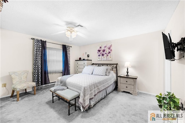 bedroom featuring light colored carpet, baseboards, ceiling fan, and a textured ceiling