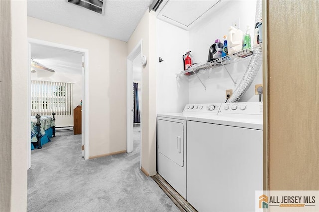 laundry room with independent washer and dryer, light carpet, a baseboard radiator, and baseboards