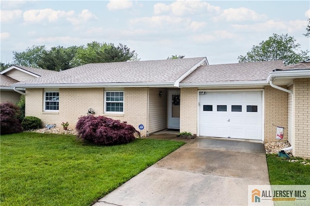 ranch-style house with a garage, a front yard, brick siding, and driveway