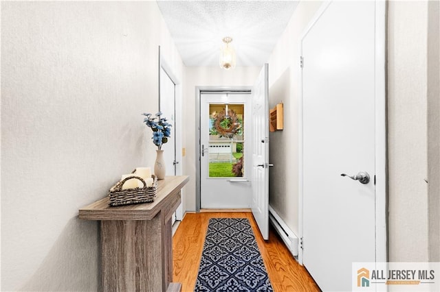 entryway with a baseboard heating unit and light wood-type flooring