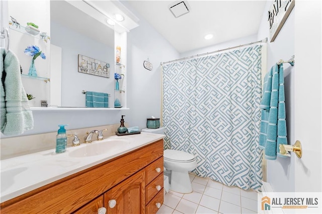 bathroom featuring tile patterned floors, vanity, toilet, and curtained shower