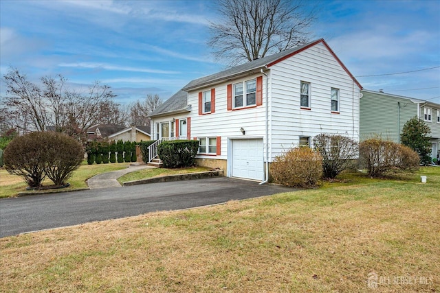 view of side of home featuring a garage and a yard