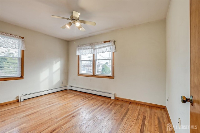 empty room with baseboard heating, ceiling fan, plenty of natural light, and light wood-type flooring