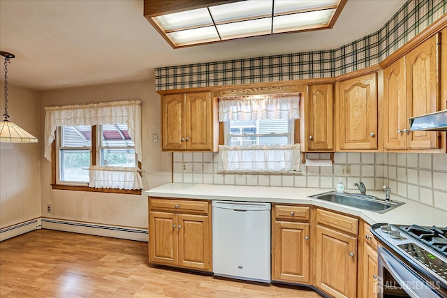 kitchen with pendant lighting, sink, stainless steel gas stove, white dishwasher, and light wood-type flooring