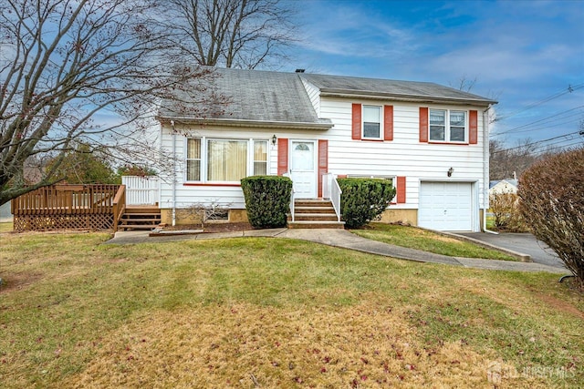 tri-level home featuring a garage, a deck, and a front yard