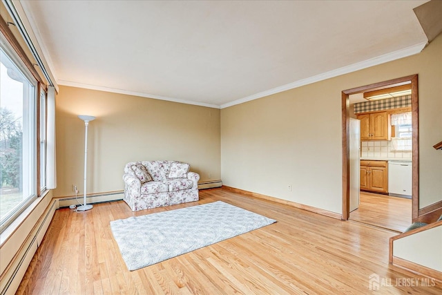 unfurnished room featuring a baseboard heating unit, crown molding, and light hardwood / wood-style flooring