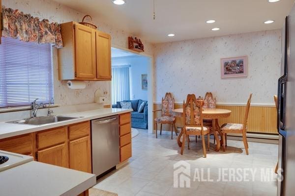 kitchen with a baseboard radiator, appliances with stainless steel finishes, and sink