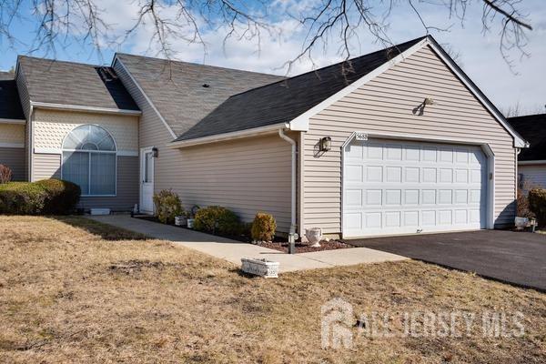 exterior space with a garage and a front lawn