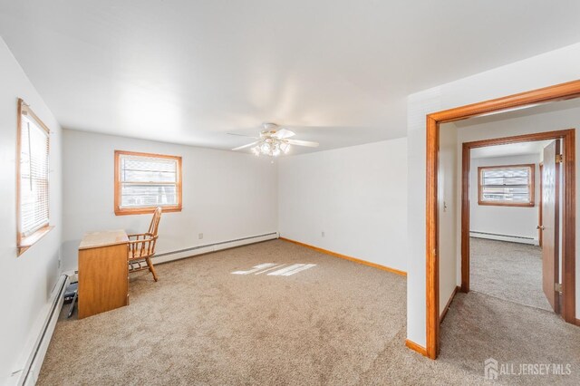 carpeted empty room featuring plenty of natural light and a baseboard radiator