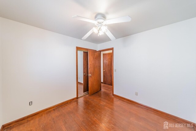 unfurnished room featuring hardwood / wood-style floors and ceiling fan