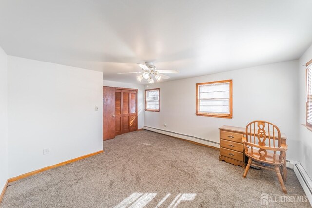 unfurnished bedroom with ceiling fan, carpet floors, a baseboard radiator, and a closet