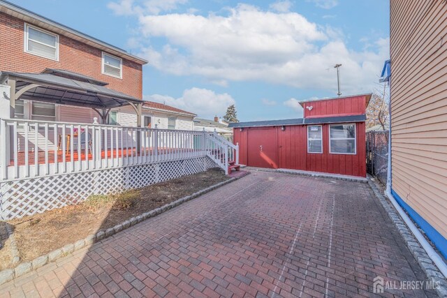 view of patio / terrace with a wooden deck and a gazebo