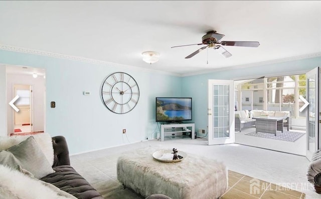 carpeted living area featuring crown molding, ceiling fan, and french doors
