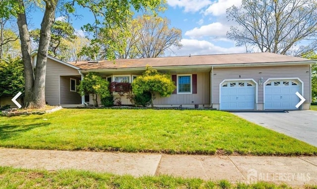 view of front facade with an attached garage, asphalt driveway, and a front yard