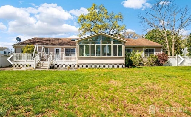rear view of house with a deck and a sunroom