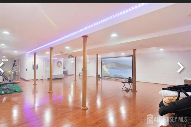 finished below grade area featuring wood finished floors and recessed lighting